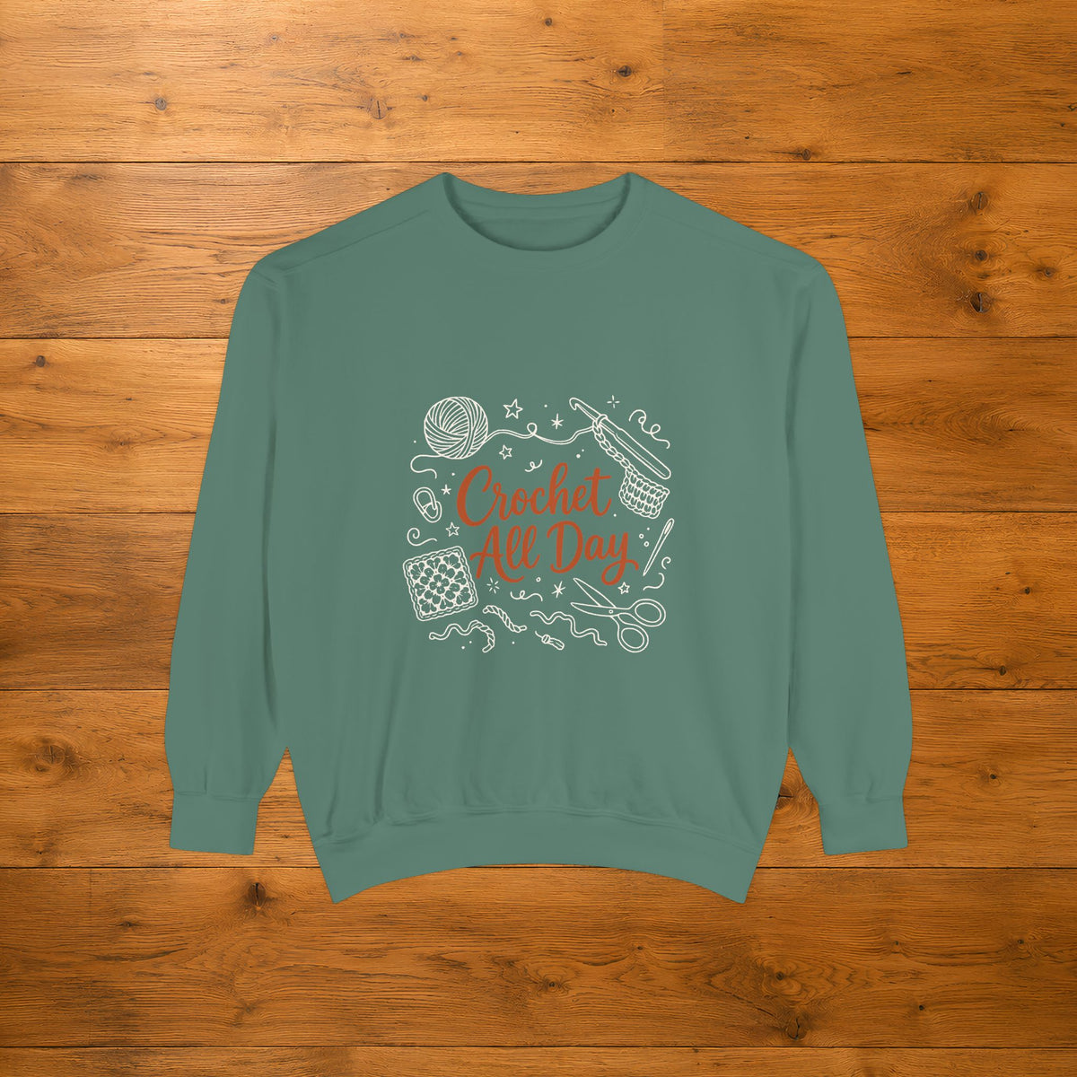 Light Green Crochet All Day crewneck sweatshirt laid flat on a wooden table